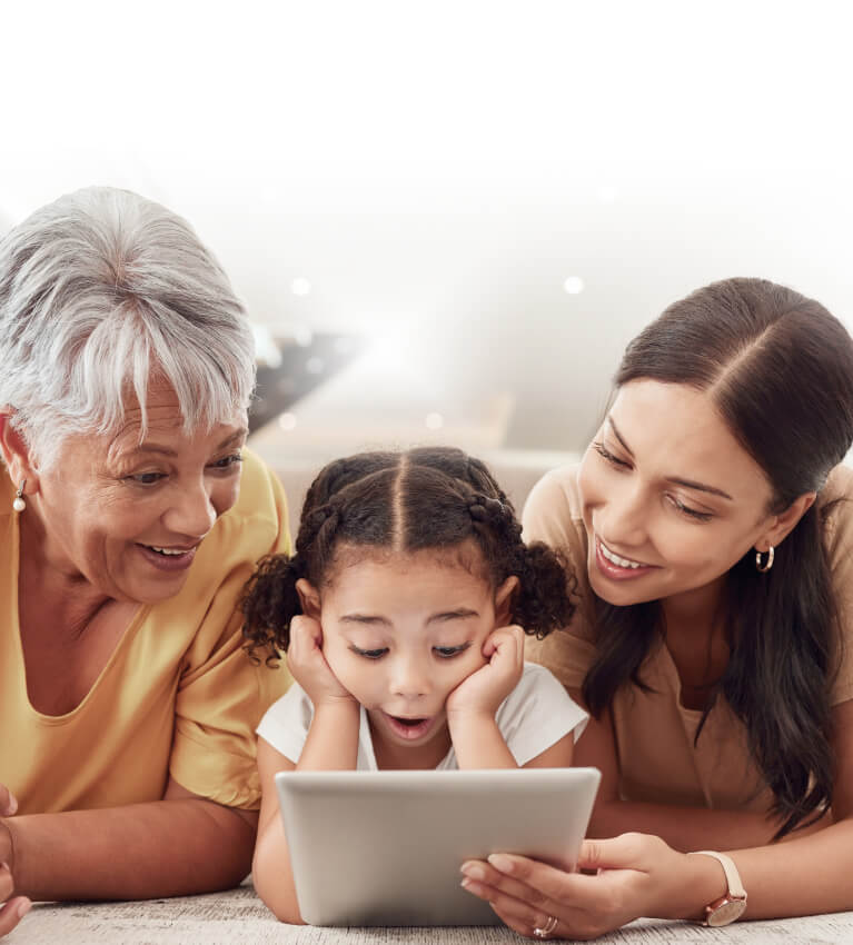 3 generations of women looking at tablet