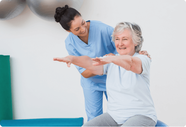 A physical therapist helps a resident stretch