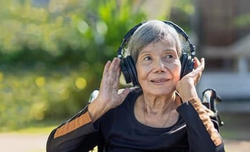 Woman listening to Coro Health's Music First therapeutic programming.