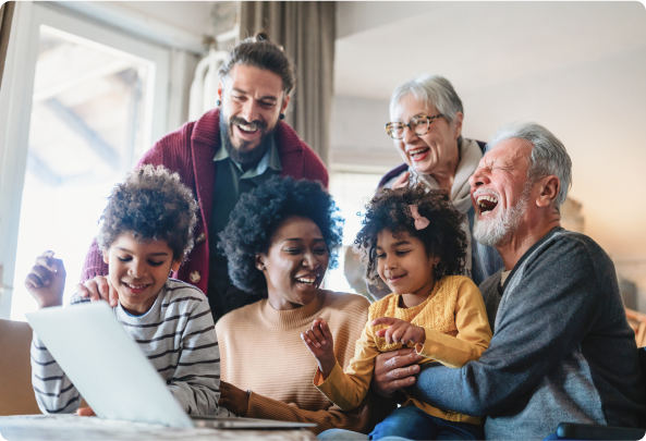 A family engages around a laptop