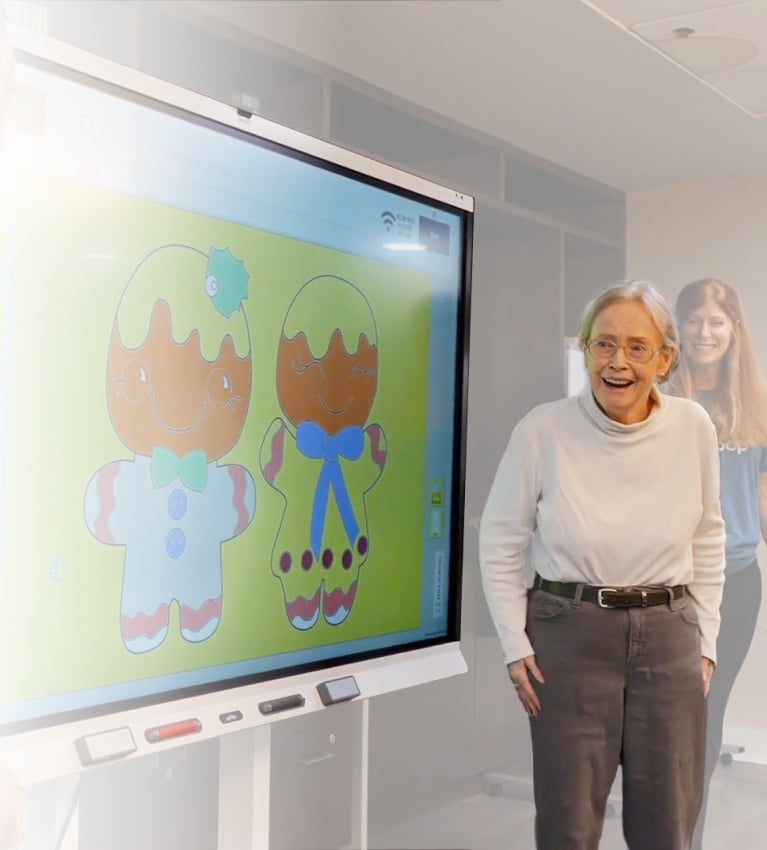 Woman standing in front of a touchscreen TV