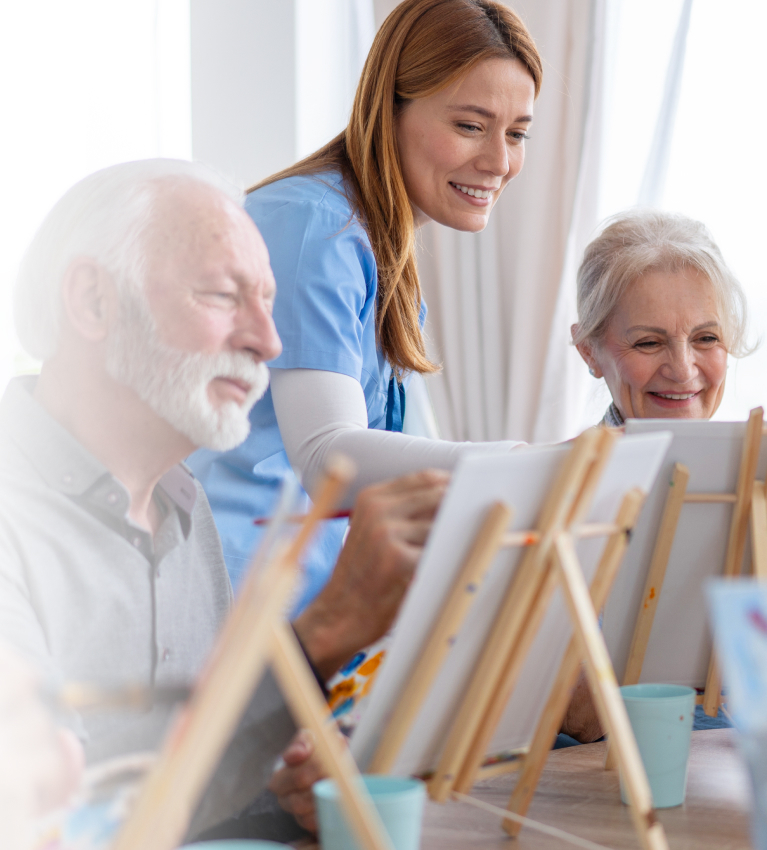 3 people painting on easels