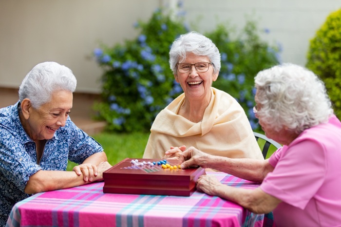 3 women playing a board game 3 women playing a board game